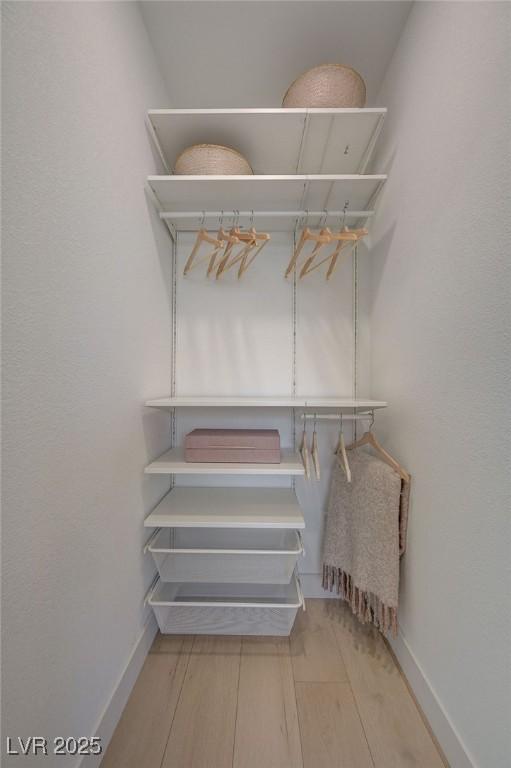 spacious closet with wood finished floors