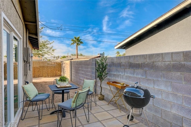 view of patio / terrace with a fenced backyard and a grill