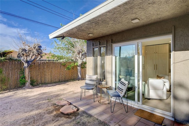 view of patio / terrace featuring fence