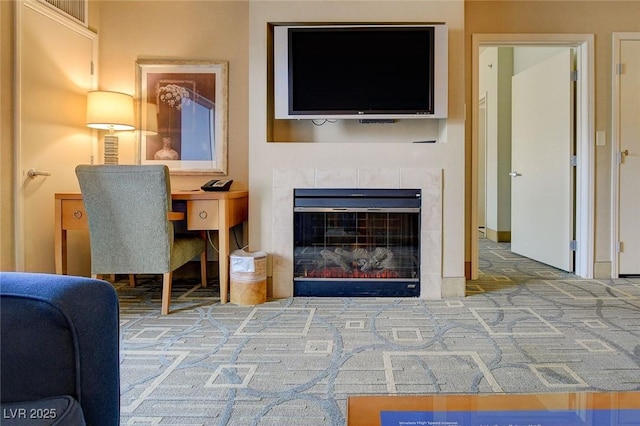 living room featuring a tiled fireplace and carpet floors