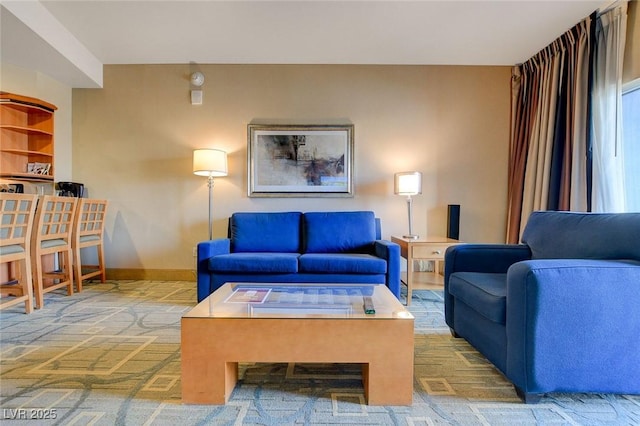living area featuring baseboards and carpet flooring