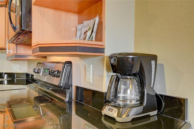 interior details with black microwave and stainless steel range with electric stovetop