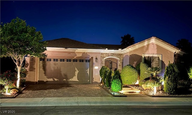 2312 Indigo Island St, Henderson, NV 89044 - single story home with decorative driveway, an attached garage, a tile roof, and stucco siding