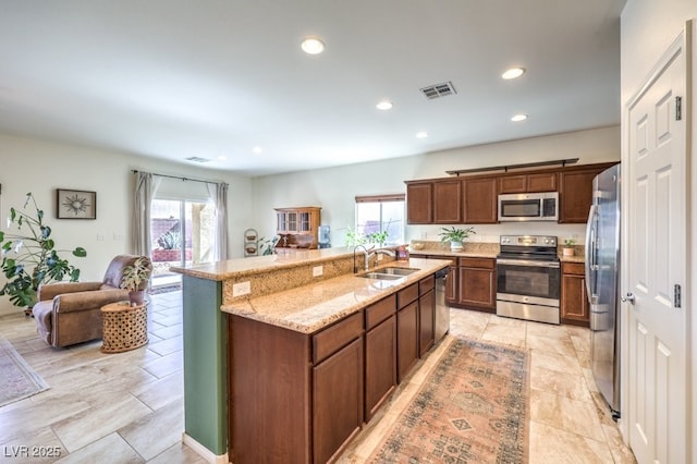 kitchen with a sink, a healthy amount of sunlight, stainless steel appliances, and visible vents