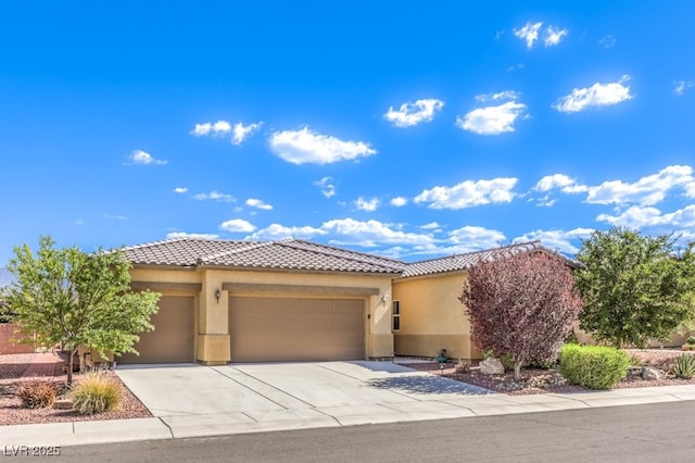 view of front of house with an attached garage, driveway, a tile roof, and stucco siding