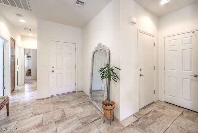 foyer entrance featuring visible vents, recessed lighting, and baseboards