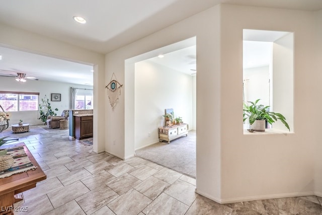 corridor featuring recessed lighting and baseboards