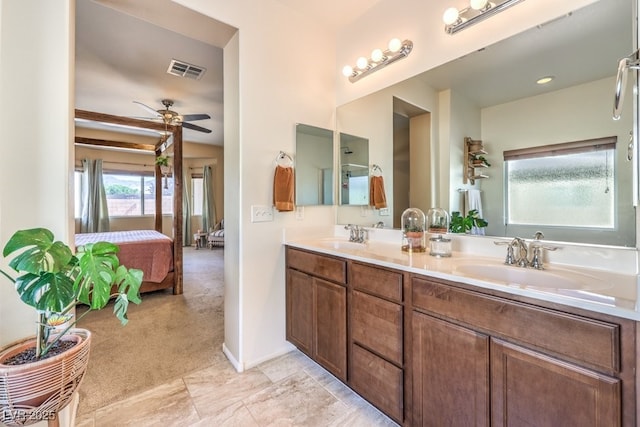 full bath with a sink, ceiling fan, connected bathroom, and visible vents