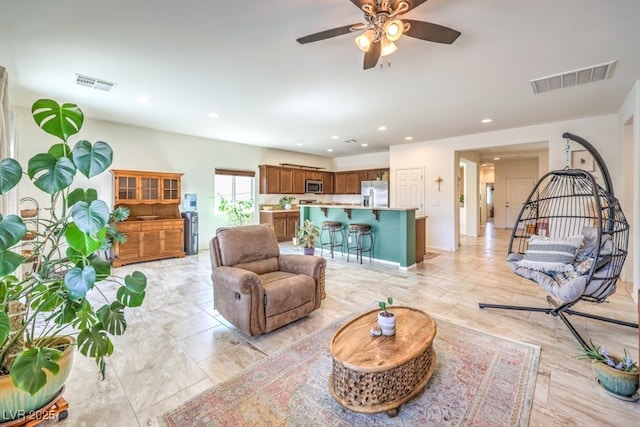 living area featuring recessed lighting, ceiling fan, and visible vents