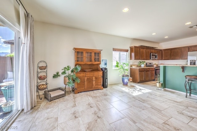 kitchen featuring recessed lighting, light countertops, and appliances with stainless steel finishes