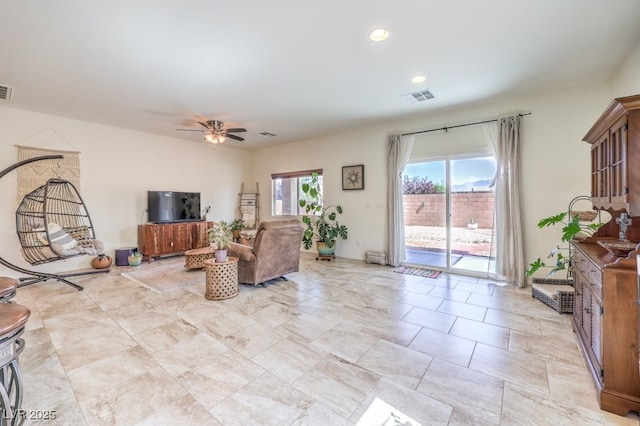 living area featuring visible vents, a ceiling fan, and recessed lighting