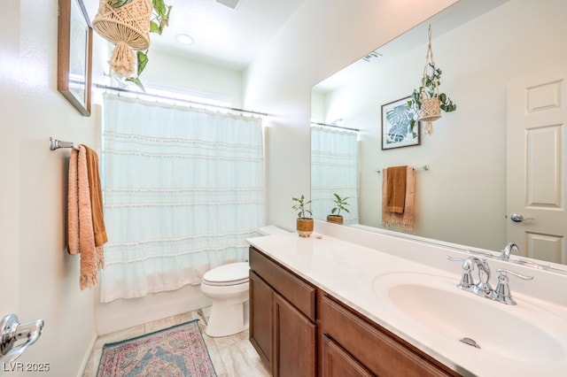full bathroom featuring toilet, visible vents, and vanity