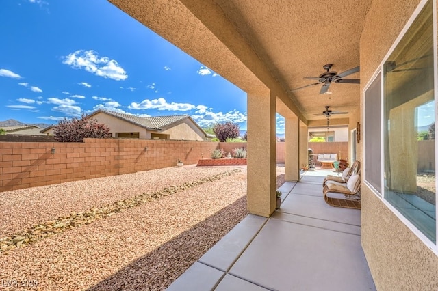 view of patio featuring a fenced backyard and ceiling fan