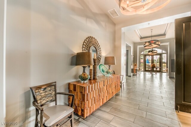 5500 E Volterra Dr, Pahrump, NV 89061 - hallway with a raised ceiling, crown molding, and french doors
