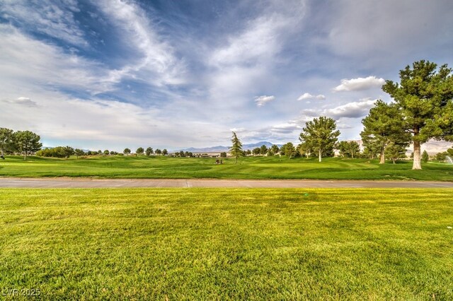 5500 E Volterra Dr, Pahrump, NV 89061 - surrounding community with a mountain view, a lawn, and view of golf course