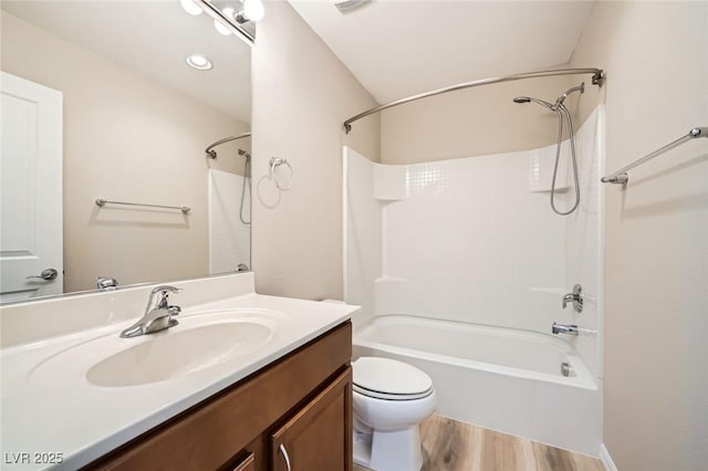full bath featuring vanity, toilet, wood finished floors, and bathtub / shower combination