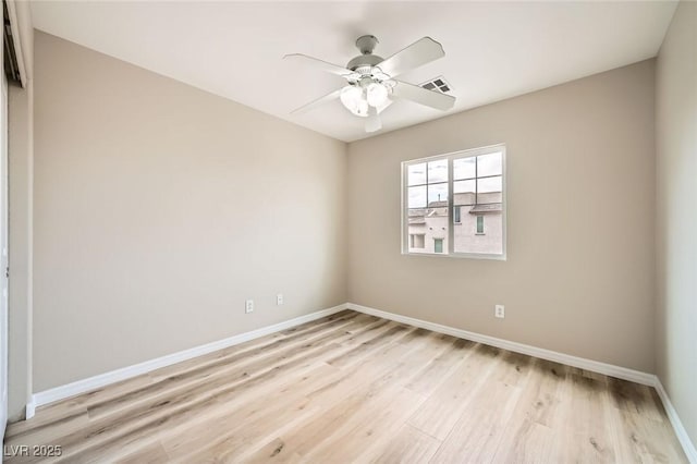 spare room with baseboards, visible vents, ceiling fan, and light wood-type flooring
