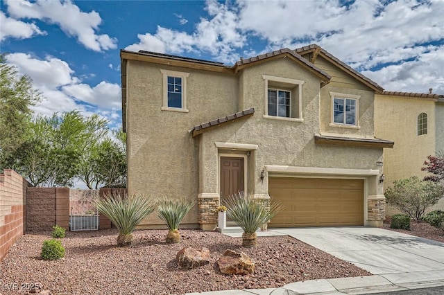 view of front of house with fence, stucco siding, concrete driveway, an attached garage, and a tile roof