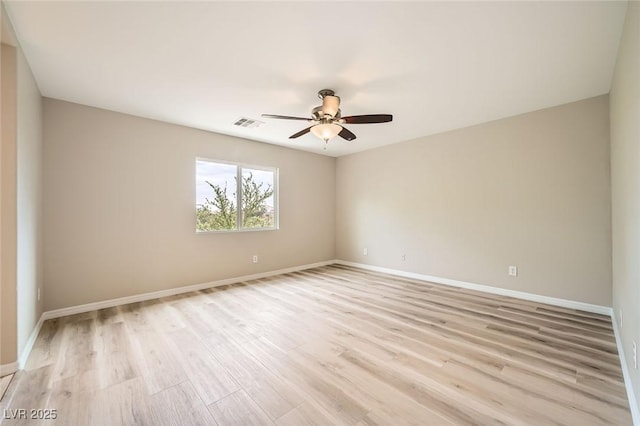 spare room featuring baseboards, a ceiling fan, light wood finished floors, and visible vents