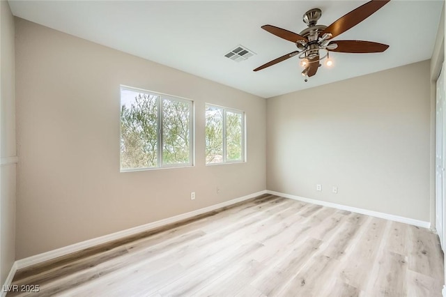 unfurnished room with baseboards, ceiling fan, light wood-style flooring, and visible vents