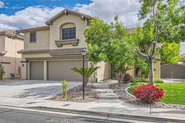 traditional-style home featuring a garage, stucco siding, a gate, and concrete driveway