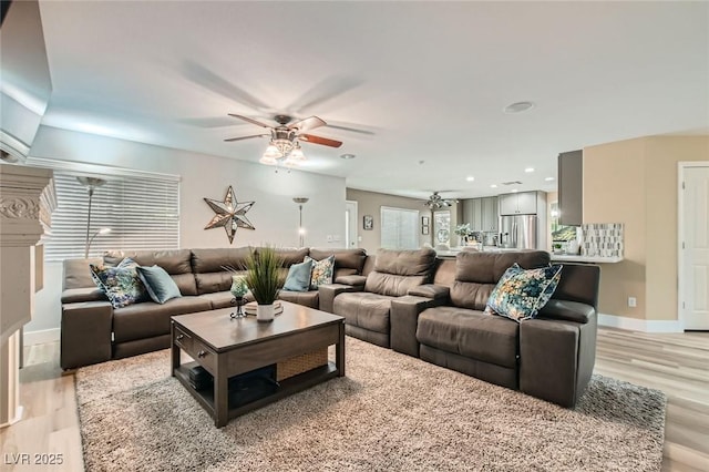 living room with light wood-type flooring, recessed lighting, baseboards, and ceiling fan