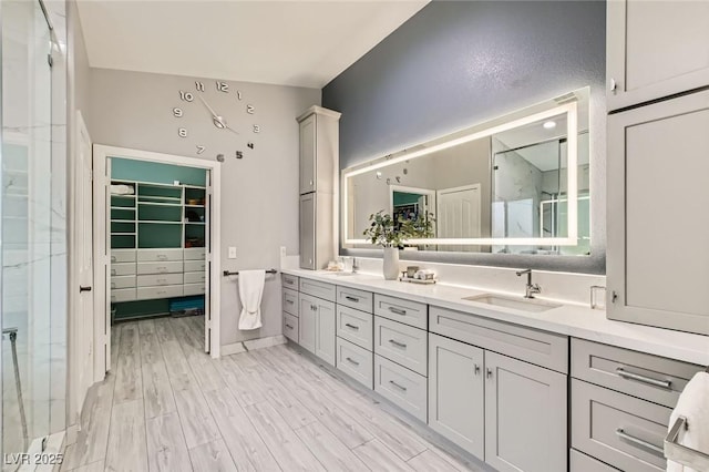 8217 Fritzen Ave, Las Vegas, NV 89131 - full bath with a walk in closet, double vanity, wood finished floors, and a shower with shower door