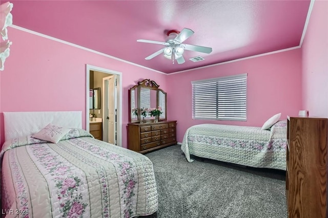 carpeted bedroom with crown molding, ceiling fan, visible vents, and connected bathroom