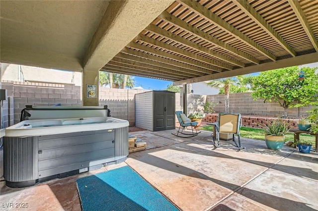 view of patio with an outdoor structure, a fenced backyard, a hot tub, and a storage shed