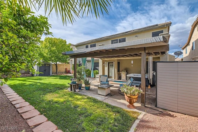 back of property featuring a patio, stucco siding, a storage unit, a lawn, and a hot tub