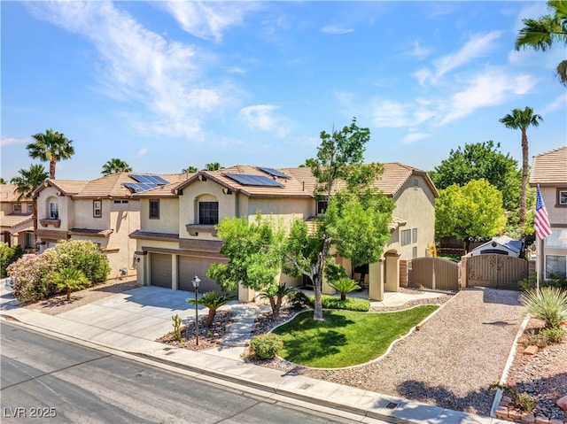 8217 Fritzen Ave, Las Vegas, NV 89131 - view of front of house with a gate, stucco siding, a garage, concrete driveway, and roof mounted solar panels