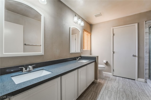 bathroom with visible vents, a sink, marble finish floor, and toilet