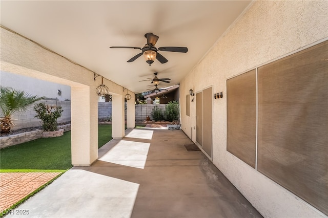 view of patio / terrace with fence and a ceiling fan