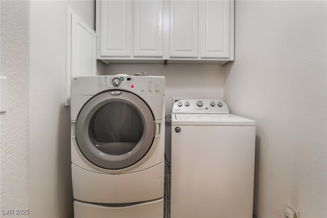 laundry room featuring cabinet space and washing machine and clothes dryer