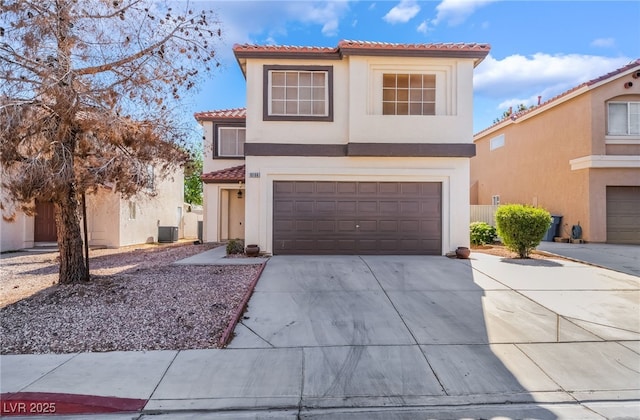 view of front of property with an attached garage, driveway, a tile roof, and stucco siding