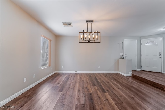 unfurnished dining area with a chandelier, baseboards, visible vents, and dark wood-type flooring
