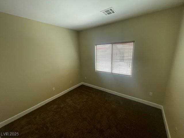 137 Coronation Ave, Las Vegas, NV 89123 - unfurnished room with baseboards, visible vents, and dark carpet