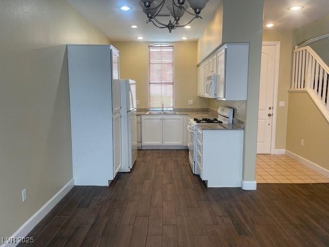 137 Coronation Ave, Las Vegas, NV 89123 - kitchen with a sink, a notable chandelier, white appliances, and dark wood finished floors