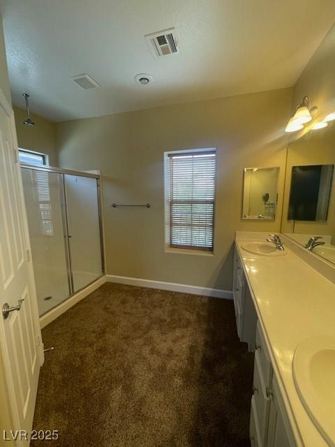 137 Coronation Ave, Las Vegas, NV 89123 - bathroom with double vanity, visible vents, a sink, and a stall shower
