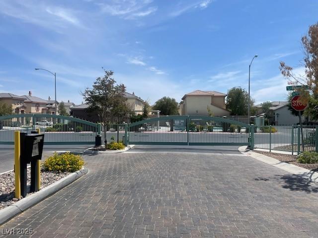 137 Coronation Ave, Las Vegas, NV 89123 - view of street featuring a gated entry, curbs, street lights, and a gate