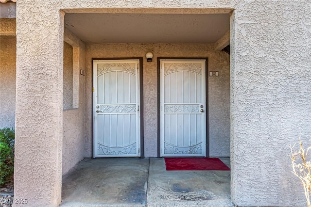 entrance to property with stucco siding