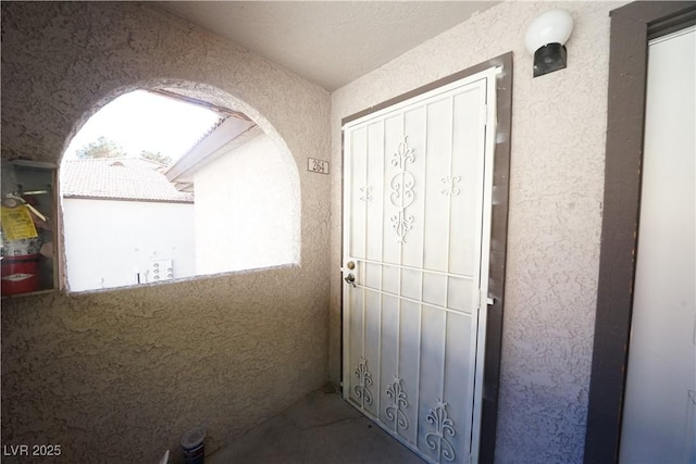 entrance to property with stucco siding