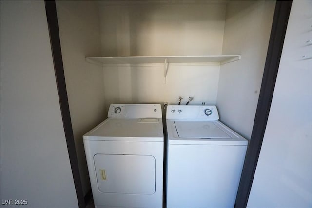 clothes washing area with laundry area and washer and clothes dryer