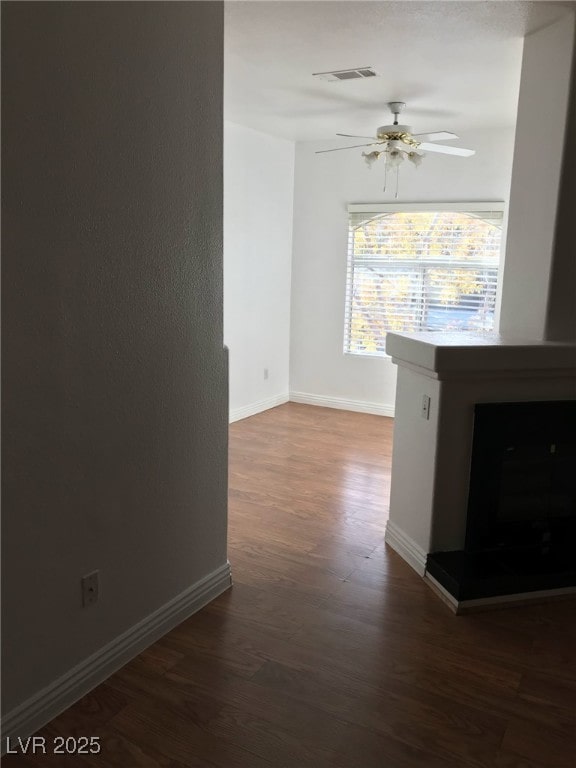 hall with baseboards, dark wood-style flooring, and visible vents