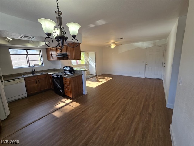 kitchen featuring white dishwasher, a sink, dark wood finished floors, visible vents, and black range with electric stovetop