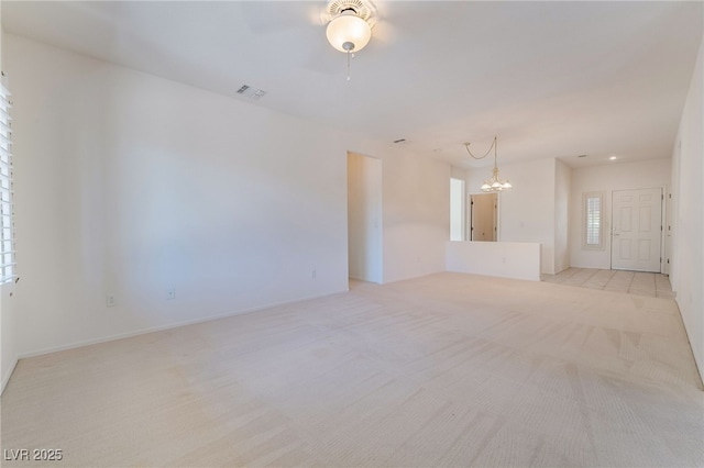 1781 Cypress Lake Ct, Henderson, NV 89012 - unfurnished living room featuring visible vents, baseboards, ceiling fan with notable chandelier, and light carpet