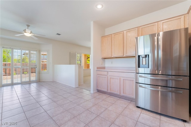1781 Cypress Lake Ct, Henderson, NV 89012 - kitchen featuring light tile patterned flooring, ceiling fan, stainless steel fridge with ice dispenser, light brown cabinets, and visible vents