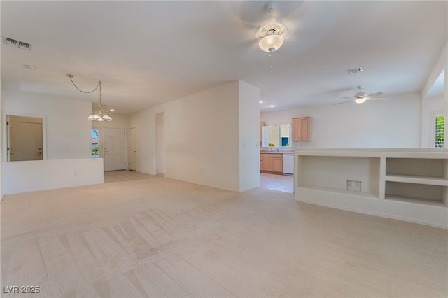 1781 Cypress Lake Ct, Henderson, NV 89012 - unfurnished living room with light colored carpet, baseboards, visible vents, and ceiling fan with notable chandelier