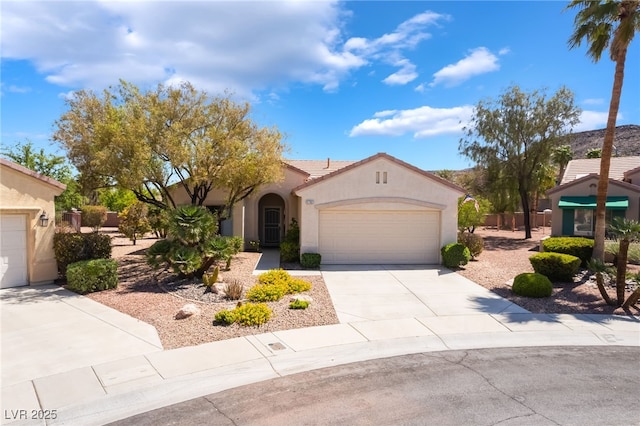 1781 Cypress Lake Ct, Henderson, NV 89012 - mediterranean / spanish home featuring a garage, stucco siding, concrete driveway, and a tiled roof