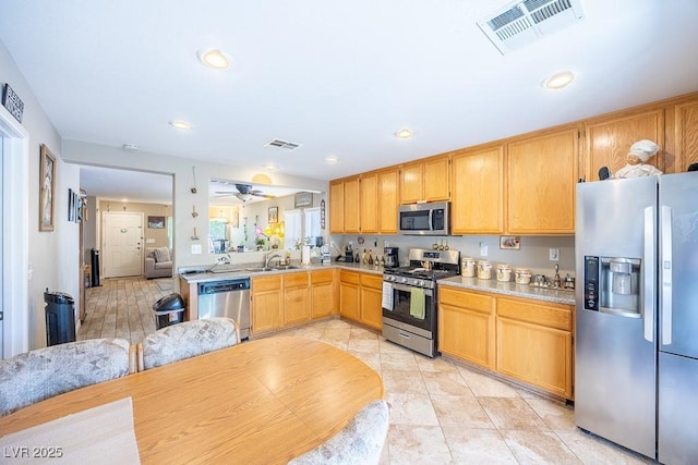 kitchen with visible vents, light countertops, and stainless steel appliances